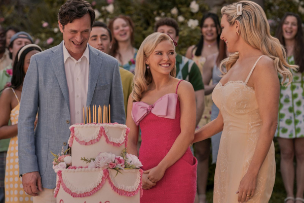 Tom Everett Scott as TK Lexi Minetree as Elle Woods and June Diane Raphael as Eva Woods stand behidn a birthday cake for...